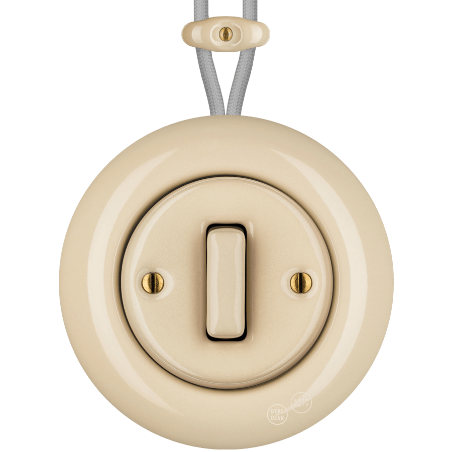 PORCELAIN KATY PATY COLONA ROUND SURFACE MOUNTED SLIM BUTTON SWITCH SAND - DYKE & DEAN